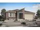 Modern home with brick and stucco, desert landscaping, and two-car garage at 25817 N 147Th Dr, Surprise, AZ 85387