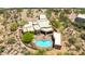 This aerial view shows a desert home with a pool and lush landscaping, offering privacy and a serene retreat at 30600 N Pima N Rd # 81, Scottsdale, AZ 85266