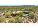 Aerial view of an estate featuring a pool, desert landscaping, and a private backyard oasis, showcasing its luxurious amenities at 30600 N Pima N Rd # 81, Scottsdale, AZ 85266