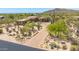 A luxurious home with desert landscaping and a winding driveway, showcasing curb appeal and natural beauty from an aerial perspective at 30600 N Pima N Rd # 81, Scottsdale, AZ 85266