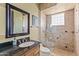 Bathroom with seamless glass shower and dark wood vanity with white ceramic sink at 30600 N Pima N Rd # 81, Scottsdale, AZ 85266