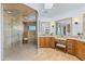 Luxurious bathroom featuring a seamless glass shower, dual vanities, and travertine flooring at 30600 N Pima N Rd # 81, Scottsdale, AZ 85266