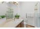 Bright bathroom featuring a vanity with neutral countertops and a glass-enclosed shower at 30600 N Pima N Rd # 81, Scottsdale, AZ 85266