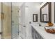Bathroom with marble floors and countertops, seamless glass shower, and dark wood fixtures at 30600 N Pima N Rd # 81, Scottsdale, AZ 85266