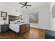 Bedroom with hardwood floors, ceiling fan, and large window letting in ample natural light at 30600 N Pima N Rd # 81, Scottsdale, AZ 85266