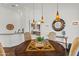 Charming dining area with designer lighting, wood floors, and views into kitchen at 30600 N Pima N Rd # 81, Scottsdale, AZ 85266