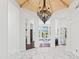 Elegant home foyer with marble floors, soaring ceilings, chandelier, and views into the living room at 30600 N Pima N Rd # 81, Scottsdale, AZ 85266