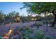 Home features desert landscaping, a private driveway, and outdoor lighting at 30600 N Pima N Rd # 81, Scottsdale, AZ 85266