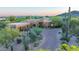 Desert home featuring a stone driveway, a three-car garage, and native landscaping at 30600 N Pima N Rd # 81, Scottsdale, AZ 85266