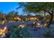 Charming desert home with a lush front yard, desert landscaping, exterior lighting, and a welcoming entrance, exuding curb appeal at 30600 N Pima N Rd # 81, Scottsdale, AZ 85266