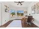 Bright office with wood floors, two electric guitars hanging on the wall, and a lovely view of desert landscaping at 30600 N Pima N Rd # 81, Scottsdale, AZ 85266