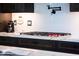 Close-up of a gas cooktop on white quartz countertops in a gourmet kitchen featuring sleek dark cabinets at 30600 N Pima N Rd # 81, Scottsdale, AZ 85266
