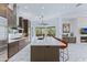 Modern kitchen with a spacious island, stainless steel appliances, and a view of the living room at 30600 N Pima N Rd # 81, Scottsdale, AZ 85266