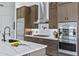 Well-appointed kitchen with a large island, stainless steel appliances, modern cabinets, and white countertops with tile backsplash at 30600 N Pima N Rd # 81, Scottsdale, AZ 85266