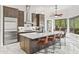 Bright kitchen showcases a large island with barstool seating, modern appliances, and sleek cabinetry with an open floorplan at 30600 N Pima N Rd # 81, Scottsdale, AZ 85266