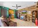 Entertainment space featuring a wet bar, wood paneling, leather furniture, and vintage decor at 30600 N Pima N Rd # 81, Scottsdale, AZ 85266