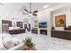 Open-concept living room with kitchen island, modern fireplace, stylish furniture, and marble floors with an open floorplan at 30600 N Pima N Rd # 81, Scottsdale, AZ 85266