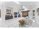 Bright living room with a fireplace, skylights, and marble floors at 30600 N Pima N Rd # 81, Scottsdale, AZ 85266