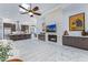 Open-concept living room showcasing a fireplace, kitchen access, and marble flooring at 30600 N Pima N Rd # 81, Scottsdale, AZ 85266