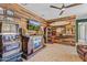 Entertainment space with wood paneling, surfboard decoration, a vintage slot machine, and a wet bar at 30600 N Pima N Rd # 81, Scottsdale, AZ 85266