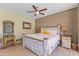 Bright main bedroom with wood-accent wall, ceiling fan, and light hardwood floors at 30600 N Pima N Rd # 81, Scottsdale, AZ 85266