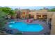 Aerial perspective of a luxurious pool area with lounge chairs and desert flora at twilight at 30600 N Pima N Rd # 81, Scottsdale, AZ 85266
