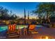Inviting pool area featuring comfortable lounge chairs, a small table, and desert landscaping, perfect for outdoor relaxation at 30600 N Pima N Rd # 81, Scottsdale, AZ 85266