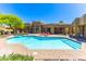 Relaxing backyard retreat with a sparkling pool, desert landscaping, lounge chairs, and covered patio at 30600 N Pima N Rd # 81, Scottsdale, AZ 85266