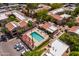 Aerial view of a community pool, hot tub, patio seating, mature landscaping, and parking at 3131 W Cochise Dr # 144, Phoenix, AZ 85051