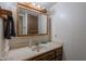 Bathroom sink with a wood vanity and a wooden framed mirror at 3131 W Cochise Dr # 144, Phoenix, AZ 85051