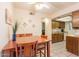 Cozy dining room area adjacent to kitchen and living room with ceiling fan at 3131 W Cochise Dr # 144, Phoenix, AZ 85051