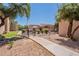 Community grounds with walkways, shade structures, desert landscaping, and building views at 3131 W Cochise Dr # 144, Phoenix, AZ 85051