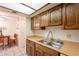 Well-lit kitchen with vintage wood cabinets, double sink, and lots of counter space at 3131 W Cochise Dr # 144, Phoenix, AZ 85051
