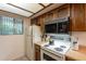Efficient kitchen featuring vintage appliances, wood cabinets, and great natural light at 3131 W Cochise Dr # 144, Phoenix, AZ 85051