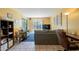 Comfortable living area featuring sofa, loveseat, bookcase, and sliding glass door at 3131 W Cochise Dr # 144, Phoenix, AZ 85051