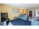 Bright living room with tv, couch, accent chair, and view of entryway and door at 3131 W Cochise Dr # 144, Phoenix, AZ 85051