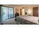 Bright bedroom with sliding door to patio, carpet flooring, and a view into the hallway at 3131 W Cochise Dr # 144, Phoenix, AZ 85051