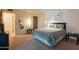 Cozy bedroom featuring a queen bed, carpeted floor, and a view of the hall and doorway at 3131 W Cochise Dr # 144, Phoenix, AZ 85051