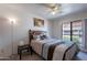 Comfortable bedroom with a ceiling fan, large window, and a queen-size bed at 3131 W Cochise Dr # 269, Phoenix, AZ 85051