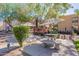 Community courtyard featuring a paved seating area, shady umbrellas, and desert landscaping at 3131 W Cochise Dr # 269, Phoenix, AZ 85051