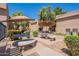 Outdoor patio area featuring picnic tables, mature trees, and lush landscaping at 3131 W Cochise Dr # 269, Phoenix, AZ 85051