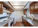 Traditional kitchen with wood cabinets, updated countertops, and white appliances at 3131 W Cochise Dr # 269, Phoenix, AZ 85051