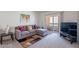 Cozy living room features a comfortable sectional sofa and access to a private balcony at 3131 W Cochise Dr # 269, Phoenix, AZ 85051