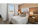 A comfortable bedroom featuring a large window, decorative posters, and neutral furnishings at 38065 W Frascati Ave, Maricopa, AZ 85138