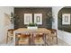 An inviting dining room with wooden table, seating for six, modern decor, and eye-catching accent wall at 38065 W Frascati Ave, Maricopa, AZ 85138