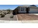 Charming single-story home with a two-car garage, and drought-tolerant front yard landscaping with a border at 38065 W Frascati Ave, Maricopa, AZ 85138