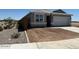Charming single-story home with a two-car garage, and drought-tolerant landscaping with an attractive border at 38065 W Frascati Ave, Maricopa, AZ 85138