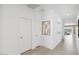 Bright hallway with tile floors, recessed lighting, and doors leading to various rooms at 38065 W Frascati Ave, Maricopa, AZ 85138