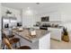 Modern kitchen featuring stainless steel appliances, granite countertops, and a center island at 38065 W Frascati Ave, Maricopa, AZ 85138