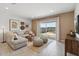 Cozy living room with sliding glass doors leading to the backyard patio at 38065 W Frascati Ave, Maricopa, AZ 85138